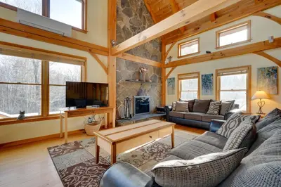 a living room with couches and a tv in a house at Secluded Vermont Retreat Outdoor Pool and Deck in Stratton
