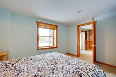 a bedroom with a bed and a window at Secluded Vermont Retreat Outdoor Pool and Deck in Stratton