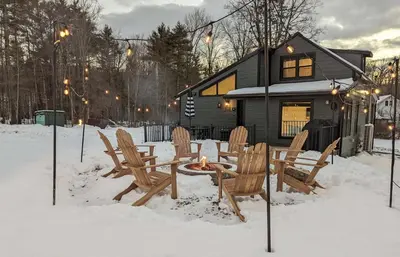 a group of chairs and a table in the snow at Acorn Lodge - Luxury Cabin, Catskills, Windham Mountain, Hunter Mountain in Cairo