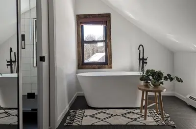 a white bathroom with a tub and a window at Acorn Lodge - Luxury Cabin, Catskills, Windham Mountain, Hunter Mountain in Cairo