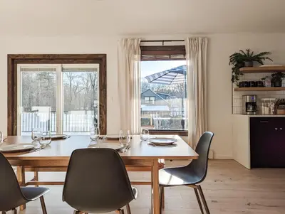 a dining room with a table and chairs and a large window at Acorn Bungalow - Luxury Cabin, Catskills, Windham Mountain, Hunter Mountain in Cairo