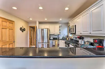 a kitchen with white cabinets and a stainless steel refrigerator at Large Deck and Resort Amenities Lake Ariel Retreat in Lake Ariel