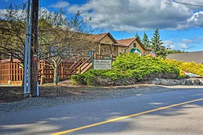 a house with a sign on the side of the road at Large Deck and Resort Amenities Lake Ariel Retreat in Lake Ariel