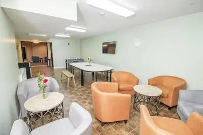 a waiting room with couches and tables and chairs at Canal Loft Hotel in New York