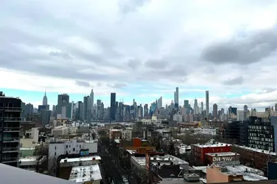 a city skyline on a cloudy day with skyscrapers at Court Square Hotel Long Island City New York , Belvilla District 6 Formerly Sonder in Long Island City