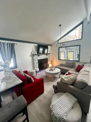 a living room with a couch and a fireplace at Amazing Poconos House . Sauna/Hot Tub/Private Pool in East Stroudsburg