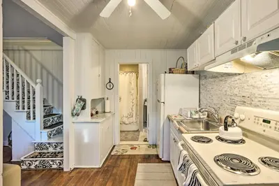 a kitchen with a white refrigerator and a sink at Charming Danbury Cottage with Lake Kenosia Access! in Danbury