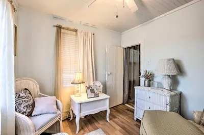 a living room with a chair and a table at Charming Danbury Cottage with Lake Kenosia Access! in Danbury