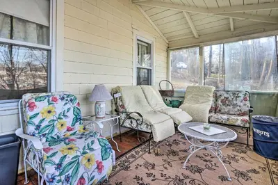 a porch with chairs and a table and windows at Charming Danbury Cottage with Lake Kenosia Access! in Danbury