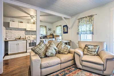 a living room with two couches and a kitchen at Charming Danbury Cottage with Lake Kenosia Access! in Danbury