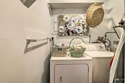 a small kitchen with a refrigerator and a washing machine at Charming Danbury Cottage with Lake Kenosia Access! in Danbury