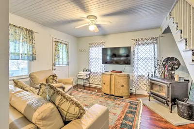a living room with a couch and a fireplace at Charming Danbury Cottage with Lake Kenosia Access! in Danbury