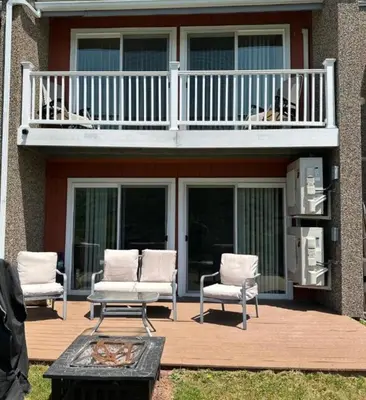 a patio with two chairs and a balcony at SPECTACULAR CATSKILLS 4 BEDROOM VACATION OASIS- Gorgeous Hunter Mountain Views! in Hunter