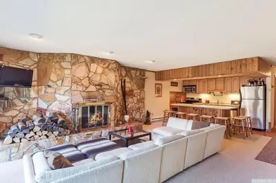 a living room with a couch and a fireplace at SPECTACULAR CATSKILLS 4 BEDROOM VACATION OASIS- Gorgeous Hunter Mountain Views! in Hunter