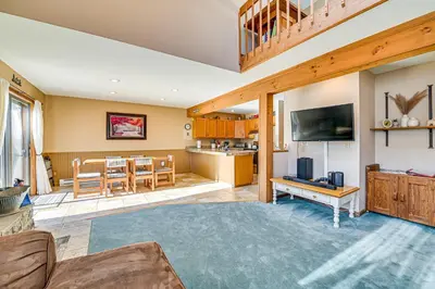 a living room with a couch and a table and a kitchen at Near Hiking and Skiing Hunter Mountain Getaway! in Elka Park