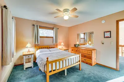 a bedroom with a bed and a dresser and a mirror at Near Hiking and Skiing Hunter Mountain Getaway! in Elka Park