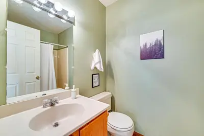 a bathroom with a sink and a toilet and a mirror at Near Hiking and Skiing Hunter Mountain Getaway! in Elka Park