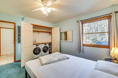 a bedroom with a bed and a washing machine at Near Hiking and Skiing Hunter Mountain Getaway! in Elka Park
