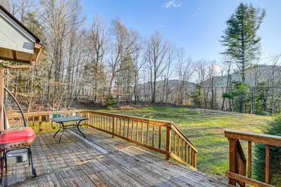 a wooden deck with a table and a grill on it at Near Hiking and Skiing Hunter Mountain Getaway! in Elka Park