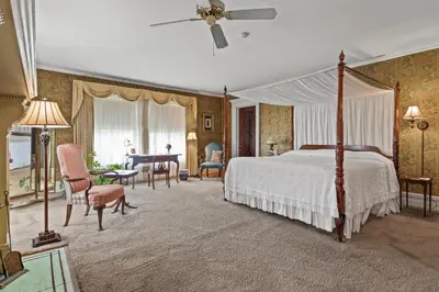 a bedroom with a canopy bed and a desk at South Shire in Bennington