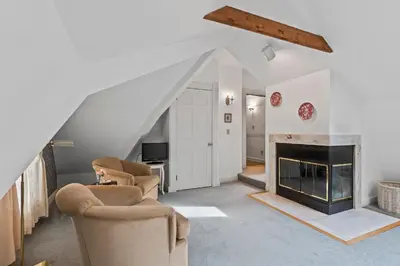 a living room with two chairs and a fireplace at South Shire in Bennington