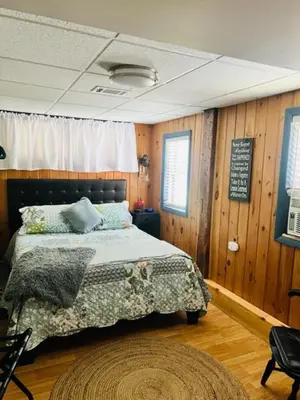a bedroom with a bed and a sign on the wall at Homesteading at 55 main in Stamford