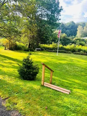 a wooden box in the grass with an american flag at Homesteading at 55 main in Stamford
