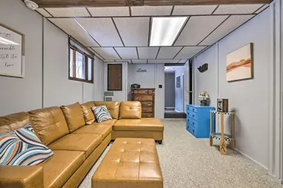 a living room with a brown couch and a blue dresser at Lake Ariel Home Less Than 1 Mi to Roaming Woods Lake! in Lake Ariel