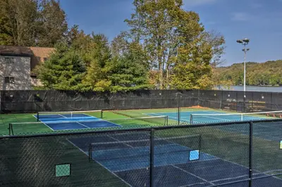 a tennis court with two tennis courts at Lake Ariel Home Less Than 1 Mi to Roaming Woods Lake! in Lake Ariel