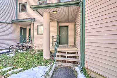 a porch of a house with a column and stairs at Next to Shawnee Mtn Ski Area Inviting Condo! in East Stroudsburg