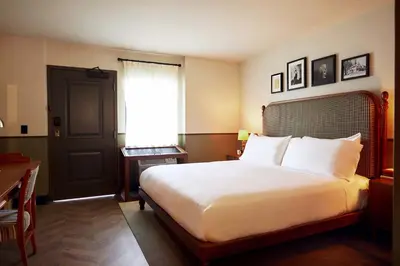 a bedroom with a large white bed and a window at Berkshires Untold in Lenox
