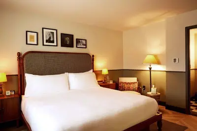a bedroom with a large white bed and two lamps at Berkshires Untold in Lenox