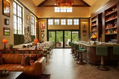a bar with couches and tables in a room at Berkshires Untold in Lenox