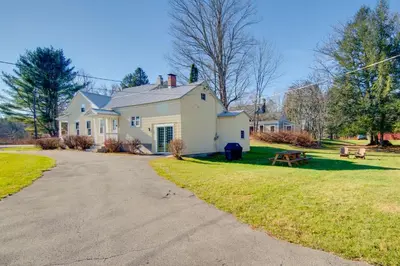 a white house with a picnic table and a driveway at Less Than 4 Mi to Cooperstown Charming Historic Home! in Fly Creek