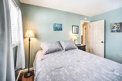 a bedroom with a large bed with blue walls at Updated Home in the Heart of Saratoga Springs in Saratoga Springs