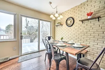 a dining room with a wooden table and chairs at Updated Home in the Heart of Saratoga Springs in Saratoga Springs