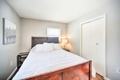 a bedroom with a large bed with white sheets at Updated Home in the Heart of Saratoga Springs in Saratoga Springs