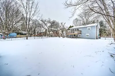 a house in a yard covered in snow at Updated Home in the Heart of Saratoga Springs in Saratoga Springs