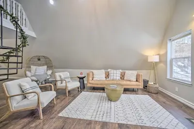 a living room with couches and chairs and a staircase at A-Frame Cabin with Hot Tub 5 Mi to Waterford! in Melrose