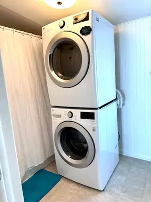 a washer and dryer stacked on top of each other at Cozy Beach - Direct Waterfront! in East Haven
