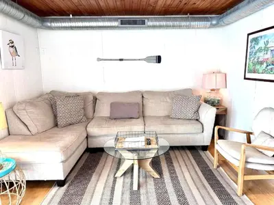 a living room with a couch and a table at Cozy Beach - Direct Waterfront! in East Haven
