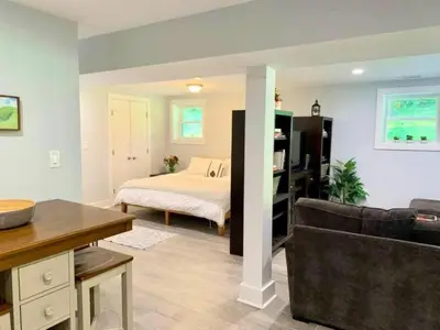 a living room with a bed and a couch at The Suite at Pound Ridge in Pound Ridge