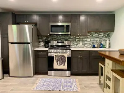 a kitchen with a stainless steel stove and microwave at The Suite at Pound Ridge in Pound Ridge