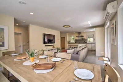 a dining room with a table and a living room at The Glabin Garrison Gem with Hot Tub and Fire Pit in Garrison