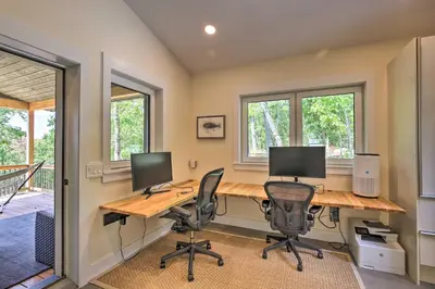 a home office with two computer monitors on a desk at The Glabin Garrison Gem with Hot Tub and Fire Pit in Garrison
