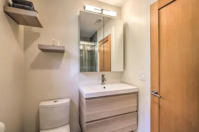 a bathroom with a sink and a toilet and a mirror at The Glabin Garrison Gem with Hot Tub and Fire Pit in Garrison