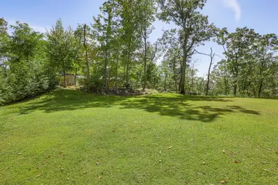 an open field with trees in the background at The Glabin Garrison Gem with Hot Tub and Fire Pit in Garrison