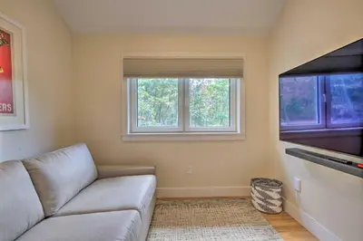 a living room with a couch and two windows at The Glabin Garrison Gem with Hot Tub and Fire Pit in Garrison