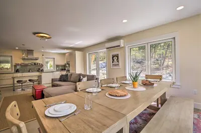 a kitchen and living room with a table and chairs at The Glabin Garrison Gem with Hot Tub and Fire Pit in Garrison
