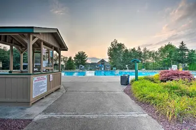 a swimming pool with a pavilion next to a park at Tobyhanna Cabin with Deck, Community Pool and Golf! in Tobyhanna